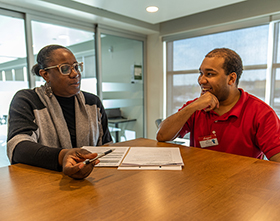 MODC Employment Services staff talking with smiling ES client