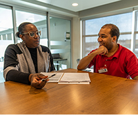 MODC Employment Services staff talking with smiling ES client