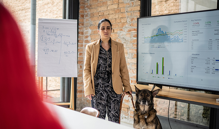 Woman with her guidedog making a presentation