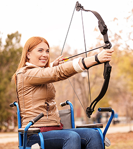Woman archer practicing in a wheelchair