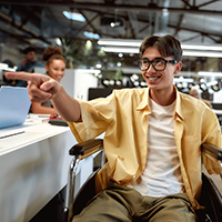 Smiling young man pointing in an office