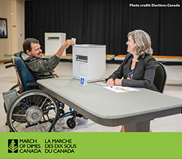 Man in wheelchair voting with smiling woman overseeing ballot