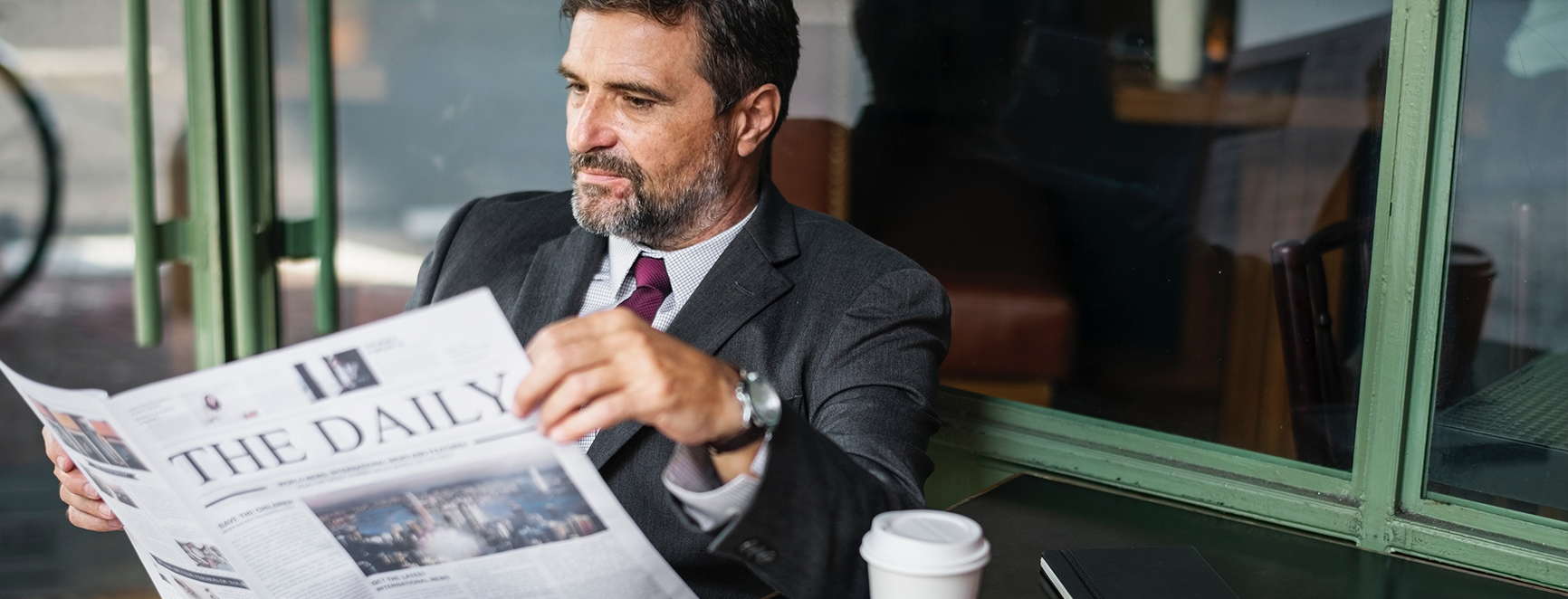 Business man reading newspaper