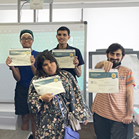 Paving the Path to Work graduates showing their certificates of completion