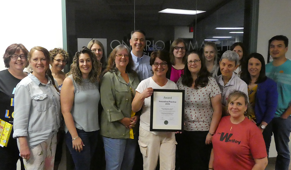 Home and Vehicle Modication Program staff celebrating an award