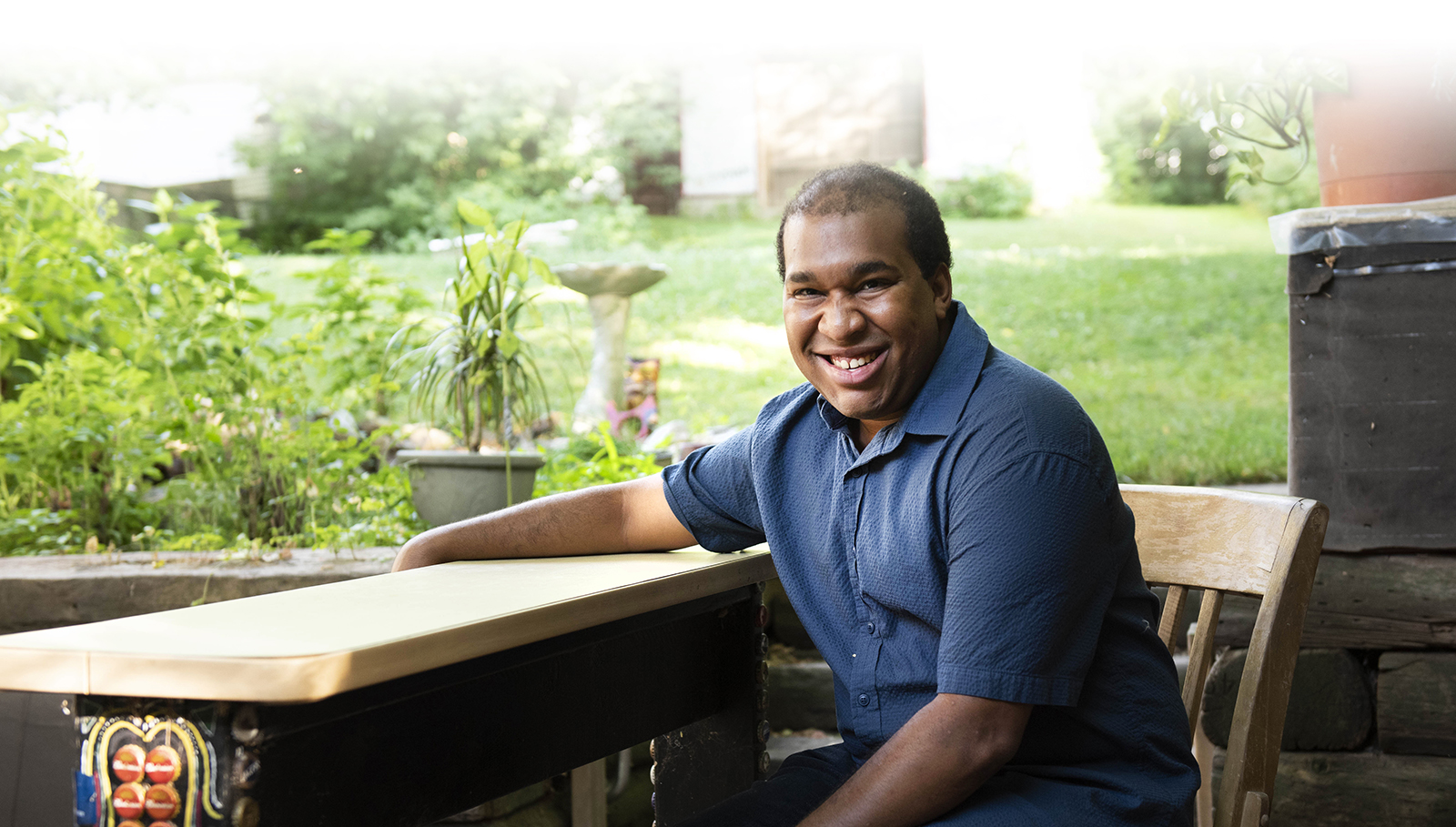 Quincy sitting at backyard table