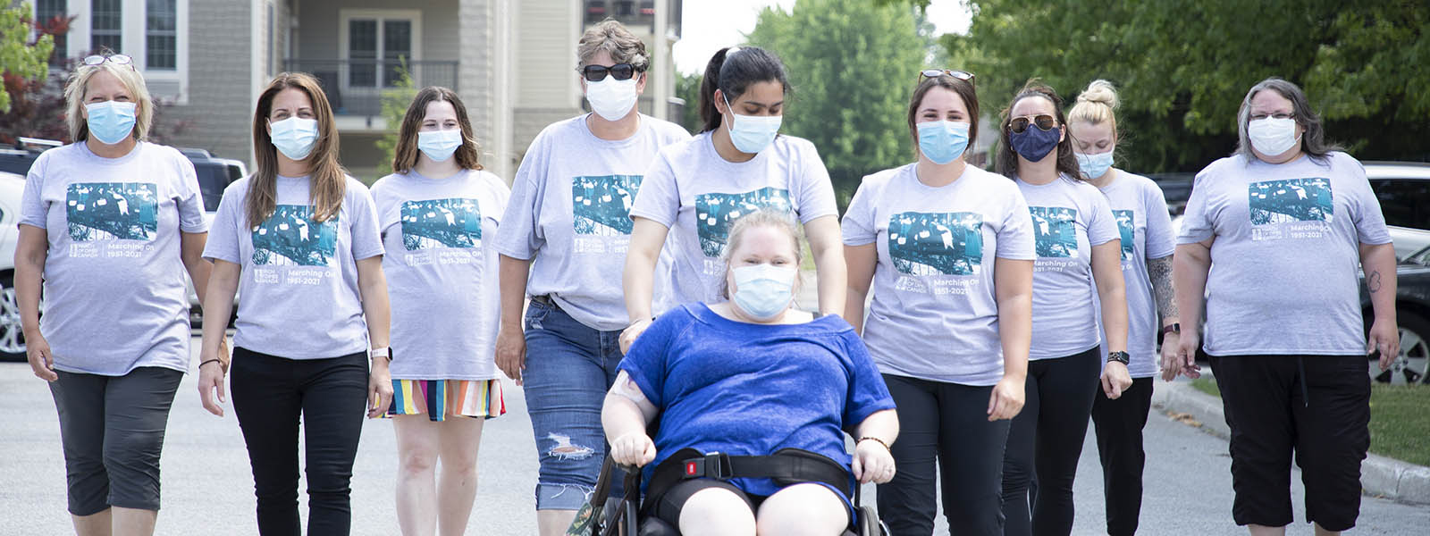 Maxwell House staff and a client walking in a line