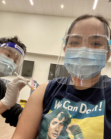 Smiling woman getting a vaccine shot