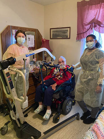 Two MODC staff and client in her home