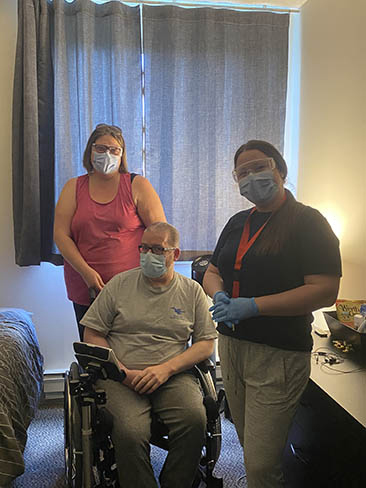 Two Community Support Services staff and client