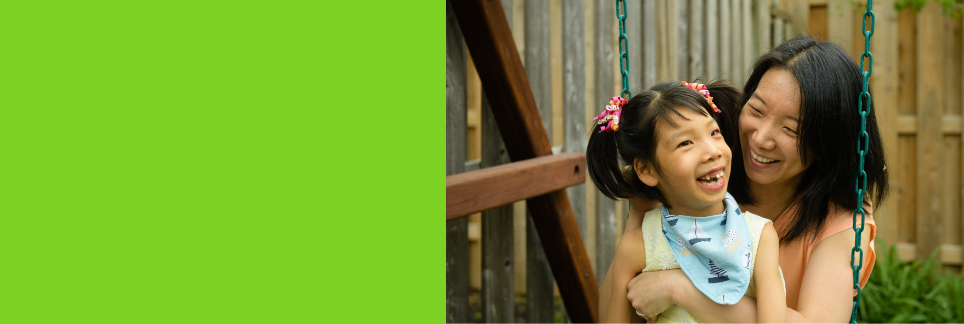 Smiling Emily on a swing with her mother