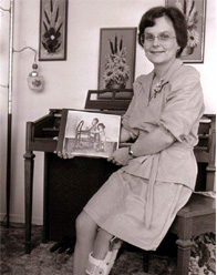 Adult polio survivor holding image of herself as a child using a walker