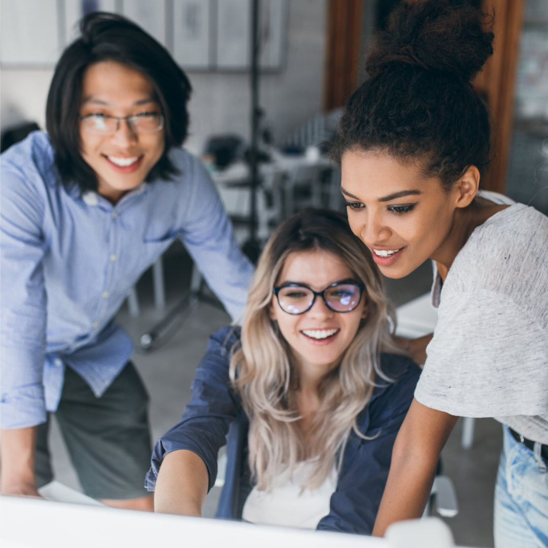 Three young people at work collaborating on a computer