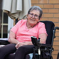 Senior woman Rose sitting on her back porch