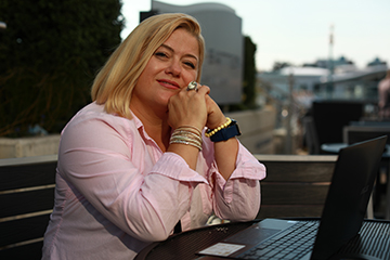 Liubov Moisieieva sitting in front of a laptop