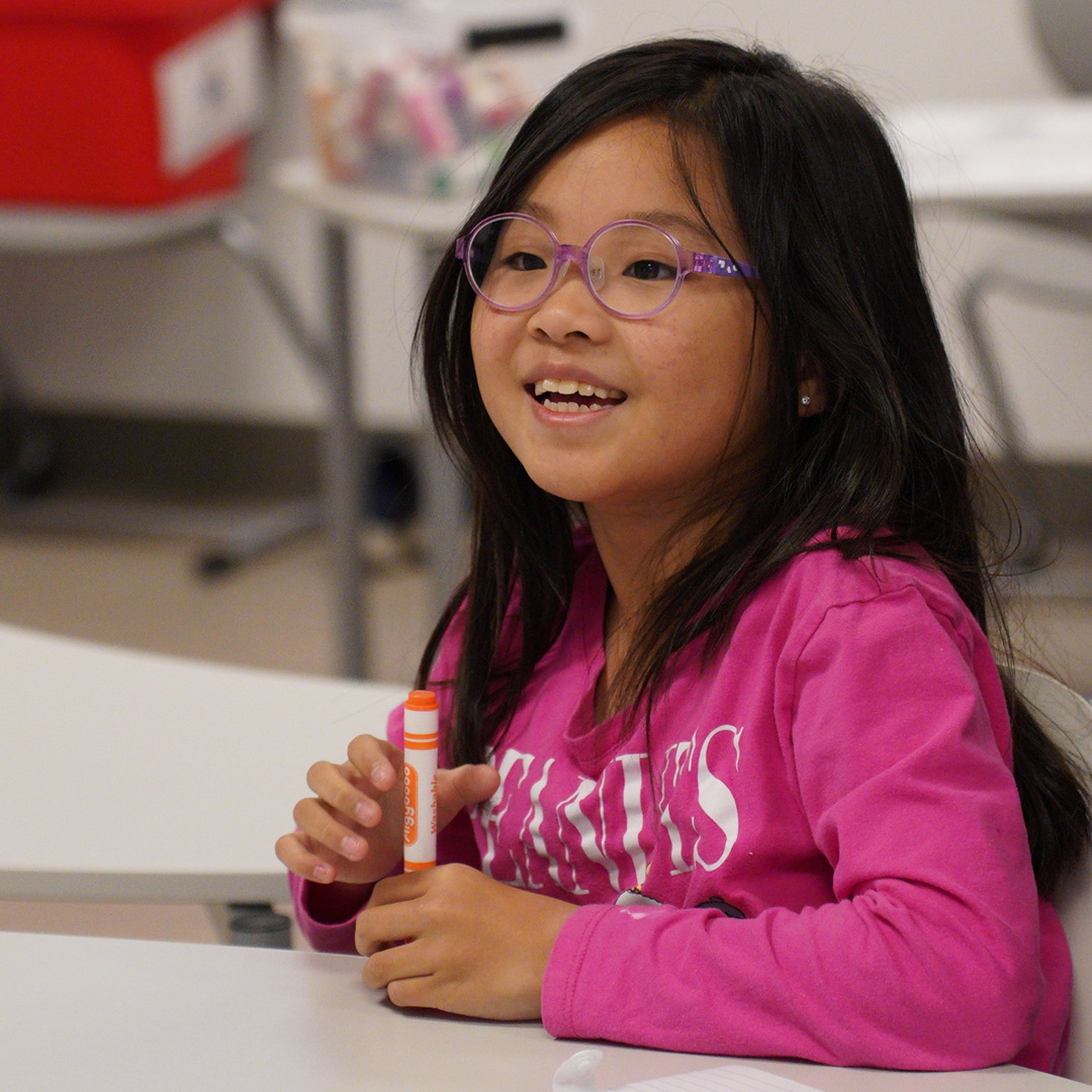Young girl with glasses smiling