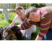 Two women petting a dog