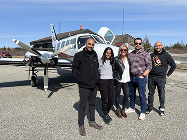 Northern Medical Clinic doctors in front of plane