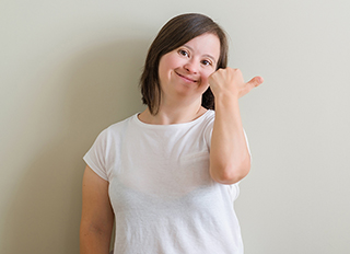 Smiling woman giving a thumbs up