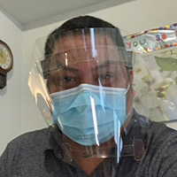 Herald Sarie behind face mask